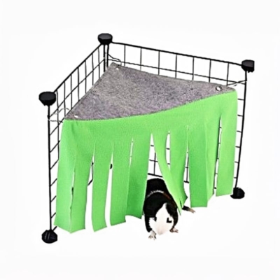 Green fleece corner tent hideout clipped into the corner of a guinea pig cage.