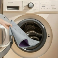 C&C Cage 2x4 purple fleece liner easy to wash and quick dry purple C&C cage liner being placed into washing machine for easy wash and quick dry